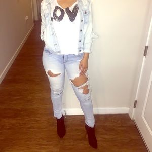 Distressed blue denim jeans